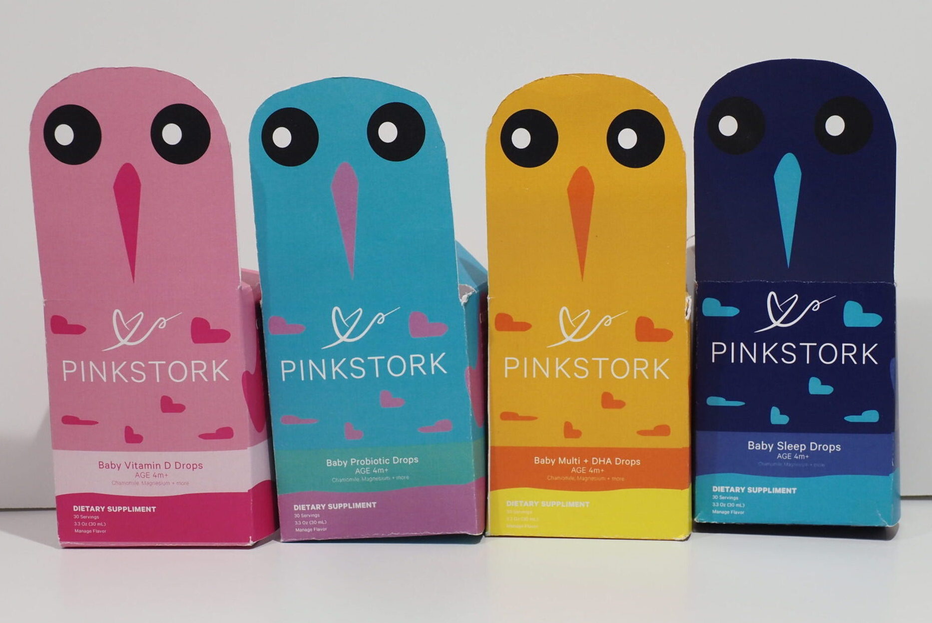 Four stork-shaped packages all in different colors next to each other.