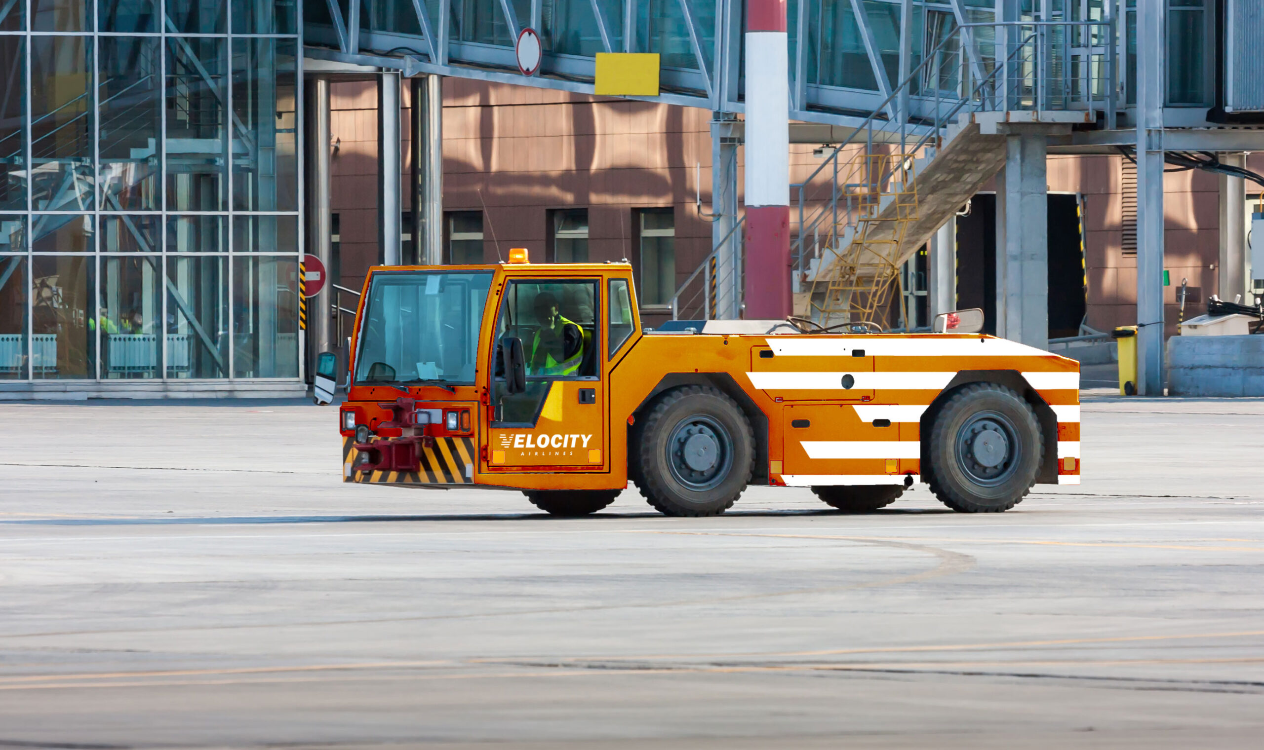 Pushback-Truck Pushback vechicle of Velocity Airlines aircraft with orange paint and white stripes.